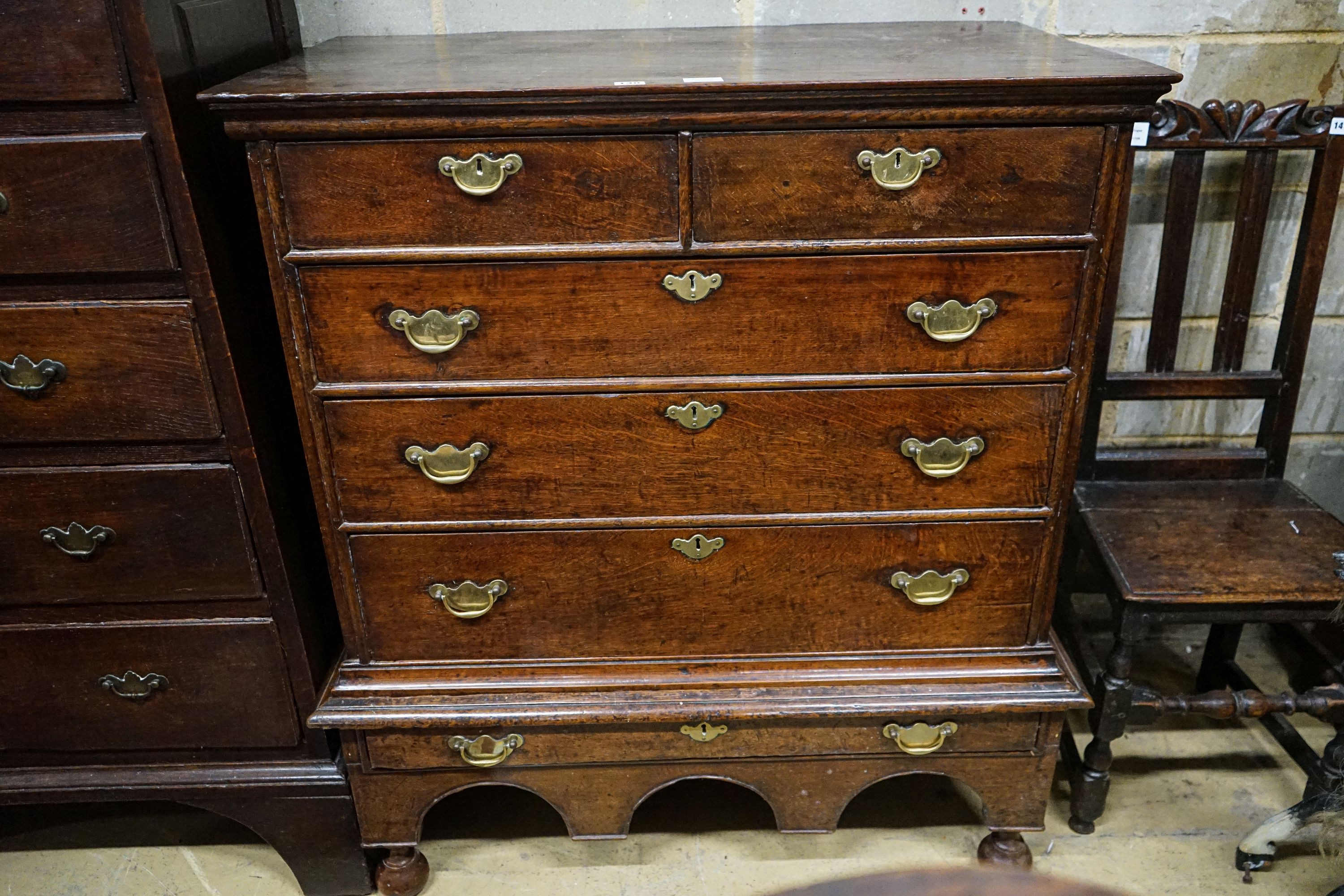 An early 18th century oak chest on stand, fitted two short and four long drawers, width 106cm, depth 56cm, height 117cm